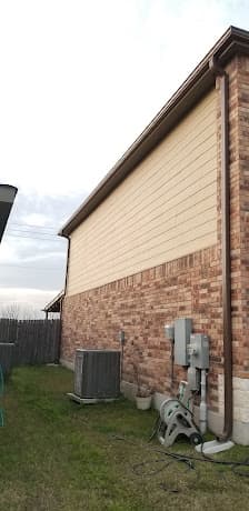 Exterior siding and trim repair on a brick home
