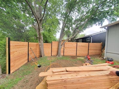 Cedar privacy fence installation around a backyard